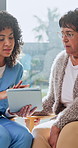 Senior, woman and nurse in house with tablet, conversation and medical research for wellness advice. Caregiver, pensioner or person in home with tech, recommendation or feedback for healthcare report