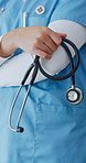 Doctor, hands or arms crossed in hospital with stethoscope, cardiology specialist or medical expertise. Confident, person or physician in clinic with cardiologist tools, healthcare experience or job.