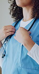 Medical, nurse or hands in hospital with stethoscope, heart check or diagnostic tool for assessment. Healthcare, woman or doctor with arms crossed, clinical equipment or instrument for cardiac exam.
