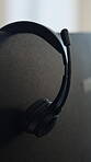 Computer, headphones and call center for customer support, help desk or advice at workplace. Headset, audio equipment and montor in office for communication, telecom or virtual assistance job