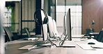 Workplace, equipment and computer with headset in call center agency for virtual assistance. Empty, space and technology with lens flare or help desk for business operations or startup in office