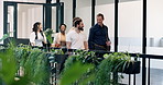 Walk, conversation and business people in office for property development, feedback or proposal. Discussion, broker and realtor in hallway for planning, teamwork or valuation at real estate agency
