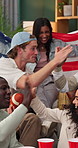 USA, flag and friends in home for sports game, match and tournament with victory on weekend. Cheer, happy and people with fist pump, celebrate and drinks for competition, goal and country support