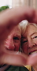 Senior, face or happy couple with heart hands in home for love, commitment or relationship together. Portrait, elderly man or woman with like emoji, shape or romantic gesture for partnership in house