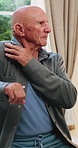 Senior, man or stretching with shoulder in home for relief, muscle tension or wellness in retirement. Active, elderly or male person with arm movement for physical activity or loosen joints in house