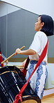 Taiko, teacher and woman with drums for practice, rehearsal or learning cultural choreography. Bachi percussion, creative and person in Japanese band for sound coordination, performance or rhythm.