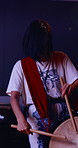 Drums, studio and woman at night for learning, choreography and practice for traditional performance. Taiko, art and person with instruments to prepare for Japanese festival, rehearsal and rhythm