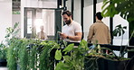 Man, smile and phone in office with break, sustainable business and text message for go green project. Happy, person and typing in corridor with tech, social media or update for eco friendly campaign