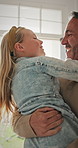 Happy, dad and hug with child in home for welcome, greeting or bonding together by door entrance. Father, kid or holding daughter with smile, comfort or embrace for childhood, love or care in house