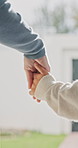 Parent, walking and holding hands with child for outdoor safety, protection or security in neighborhood. Guardian, trust or support with kid, comfort or care for weekend, holiday or bonding together