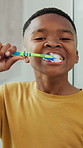 Boy, face and brushing teeth in home for dental hygiene, oral or gum care in bathroom. Portrait, kid or black child with smile or toothbrush for cleaning mouth, cavity or morning routine in house
