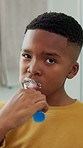 Boy, face and cleaning teeth in home for dental hygiene, oral or gum care in bathroom. Portrait, kid or black child with smile or toothbrush for brushing mouth, cavity or morning routine in house