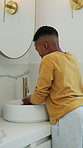 Kid, washing and hands in bathroom for hygiene, disinfection or grooming with mirror in home. Black child, boy or rinse with reflection or skincare for dental care, bacteria or germ removal in house