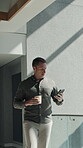 Coffee, phone and walking with business man at work for communication, feedback or update. App, drink and text message with employee typing in office for digital planning, research or schedule
