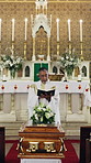 Funeral, bible or priest in church with scripture, religious sermon or mourning with spiritual reading. Preaching, coffin or man with holy book, grief verse or Christian guidance in memorial service.