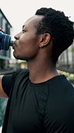 Training, fitness and black man drinking water in city for running, exercise or outdoor cardio routine. Sports, liquid and African runner person with drink for workout, hydration or body recovery