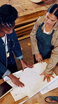 Women, carpenter and blueprint in workshop for manufacturing, products design and woodwork. Above engineer, discussion and measurement for creative, building and factory startup for small business