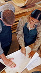 Teamwork, carpenter and blueprint in warehouse for manufacturing, products design and woodwork. Above engineer, people and meeting for creative, building and factory startup for small business