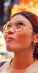 Eating, thinking and asian woman with cuisine in Japan for meal, sightseeing or taste in market. Thoughtful, female person or travel with food for outdoor dinner, snack or wonder in city or town