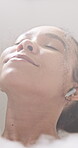 Woman, relax and bubble bath with earphones for self care, wellness and break with podcast for pampering. Music, calm and female person washing with foam in bathtub, rest and listening for wellbeing