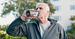 Fitness, drink water and senior man outdoor for rest, workout recovery and wellness. Exercise break, hydration and person with bottle in city for health, electrolytes or mineral in active retirement