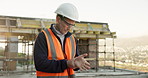 Engineer, man and wrist pain on construction site with injury, building accident and massage for relief. PPE, mature person and hurt hand outdoor with civil engineering error, sprain and overworked.