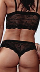 Lingerie, body and back of woman in home for confidence, alluring or seduction in bedroom. `Hot, flirty and buttocks of person with lace underwear for temptation, beauty or self love in apartment.
