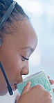 Drinking, coffee and woman with headset, telemarketing and happy with warm beverage or contemplating. Business, consultant and black person with hot tea on break, thinking and consultation services