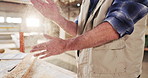 Hands, carpenter and dust in workshop with wood, smooth surface and manufacturing process. Person, clap and sanding timber for carpentry, lumber restoration and prepare finish of furniture production