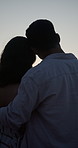 Care, back and couple hug at beach for love, support and romantic connection on vacation. Man, woman and embrace with ocean view on summer holiday, commitment and sightseeing with partner at sunset