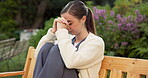 Nurse, mental health and woman with stress, outdoor and regret for healthcare mistake or overworked. Unhappy, caregiver and person with depression at park, thinking and contemplating with anxiety