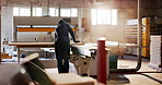 Back, carpenter and sanding in workshop with wood, smooth surface and manufacturing process. Person, sawdust and timber for carpentry, lumber restoration and prepare finish of furniture production