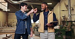 Carpentry, fist bump and men in workshop for furniture design, planning and woodworking meeting. Success, carpenter and people with clipboard for teamwork, lumber production and building agreement