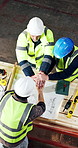 Carpentry, people and hands together in workshop with celebration, blueprint approval and success. Above, happy men and teamwork in factory for woodwork manufacturing deal, design document or support