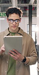 Business, man and reading in office with tablet, research and email source to confirm facts. Thinking, male person and walking in workplace with digital, proofreading and story draft for publication