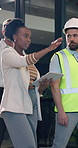 Construction, tablet and woman with team in building for renovation, feedback and planning. Architecture, contractor and person on tech for remodeling ideas, meeting and approve engineering project
