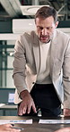 Business, man and staff in meeting with document, stats and feedback for finance report. Mature person, talking and team in office with paperwork, financial graphs and information for profit increase