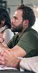 Office, meeting and businessman with team, listening and planning for investment proposal and ideas. Business, collaboration and person with colleagues, discussion or strategy for funding opportunity