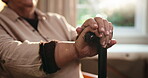 Nursing home, balance and hands with walking stick, retirement and patient in lounge or senior care. Assisted living, pensioner and elderly person with cane for support, recovery and rehabilitation