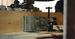 Saw, machine and hands of carpenter in warehouse for carpentry, wood project and process with plank. Woodworking, handyman and person with tools for manufacturing, joinery workshop and equipment