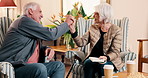 High five, puzzle and senior couple in nursing home for help with game, word search and book activity. Retirement, happy and elderly man and woman celebrate for answer, crossword success and solution