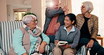 Old people, high five and nurse with book in nursing home, laughing and happy for puzzle completion. Assisted living, caregiver and solving quiz with senior group, bonding and celebration for success