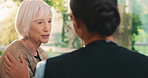 Caregiver, comfort and consultation for old woman in lounge, talking or explaining healthcare update. Assisted living, nurse and discussion with senior person, happy and compassion in nursing home