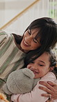 Teddy bear, hug and mother with child in home for comfort, safety or bonding in living room. Happy, support and mom embracing girl kid with plush toy for family, care and love together in house.