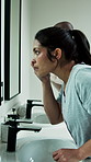 Woman, mirror and inspection in bathroom for skincare, acne breakout and skin irritation. Female person, reflection and check in home for facial blemish, clogged pores and dermatology issues with zit