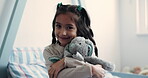 Face, hug and little girl with teddy bear in bedroom of home for comfort, love or security. Child development, morning and smile with cute kid embracing stuffed animal on bed in apartment for care