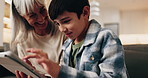 Game, grandma or boy in house with tablet, bonding activity or happy moment with online playing. Loving, grandparent or child in home with tech, digital puzzle or fun hobby with family connection.