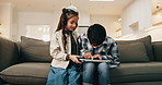 Children, siblings and tablet for win in home, entertainment game and bonding together on weekend. Kids, tech and relax on sofa for gaming success, play and click for online achievement with level up