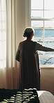 Back, old woman and open curtains by window for sunshine, wellness and wake up in home. Senior person, bedroom and thinking in house for morning routine, mindset and reflection or calm in retirement