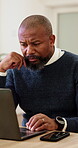 Serious, decision and businessman with laptop in office, scroll and reading financial report on app. Business, mature accountant and black person with technology for budget review and reflection